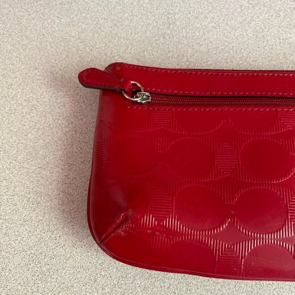 Coach Glossy Embossed Signature Wristlet
Cranberry Patent Leather Red - Picture 12 of 13
